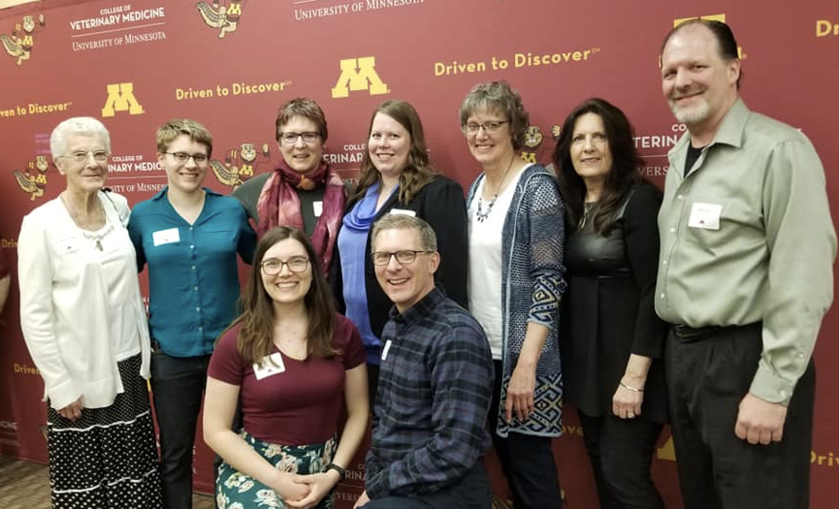 Janet Veit's family, friends, and colleagues post with Janna Erickson for a photo at 2019 Scholarship Reception