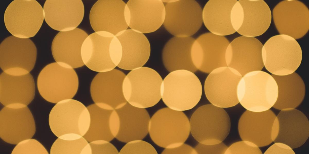 An abstract image of lights, zoomed in so they look like overlapping dots.