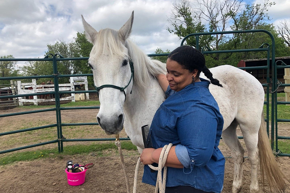 Sarah Penn with Rookie, her favorite horse at the barn where she takes riding lessons on Saturdays