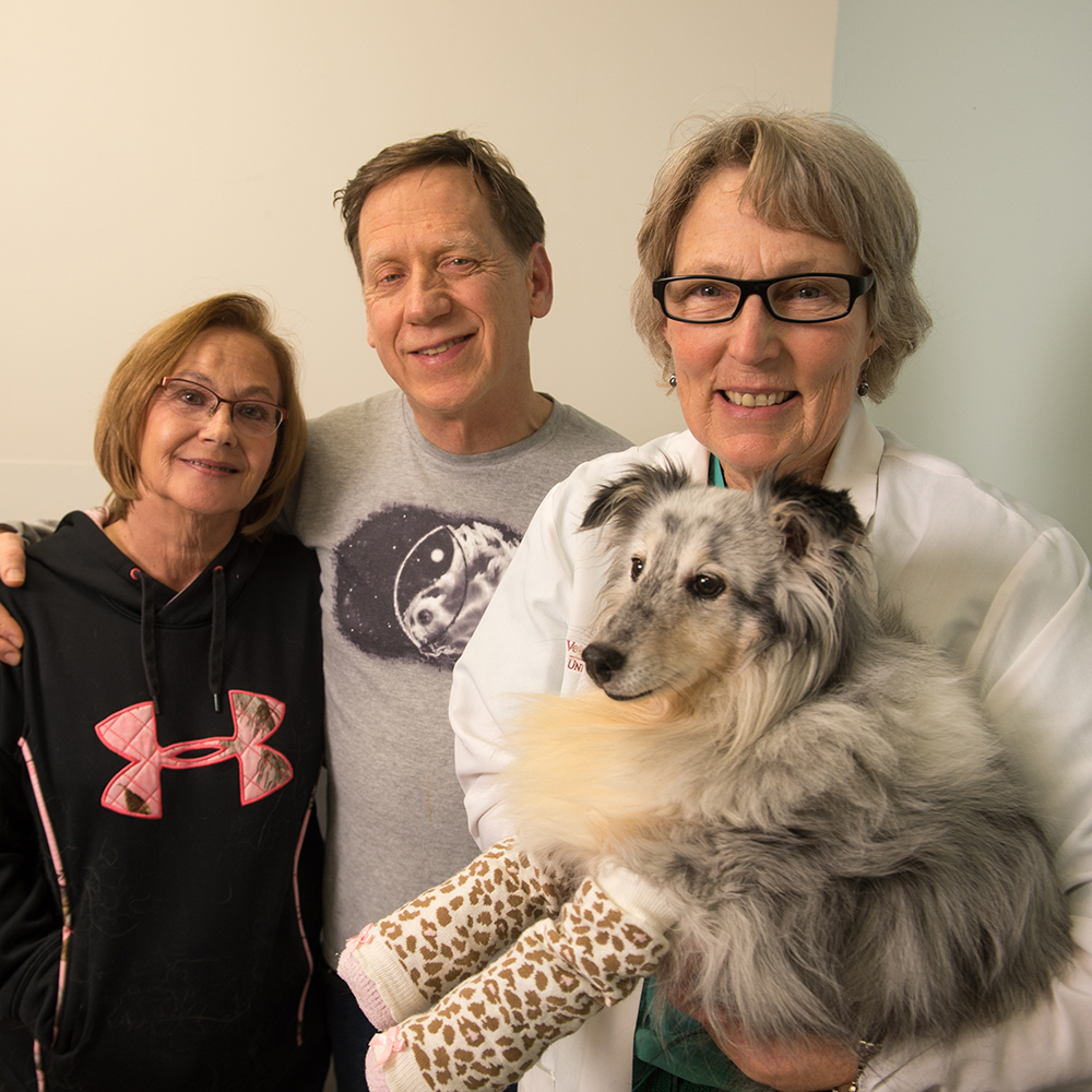 Franny with her owners and veterinarian