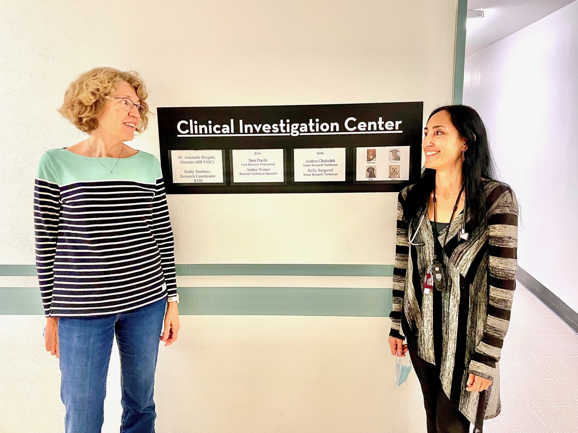 Research Manager Kathy Stuebner and Director Antonella Borgatti chat at the entrance to the Clinical Investigation Center on the St. Paul Campus.