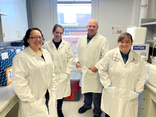Four Salmonella researchers stand together