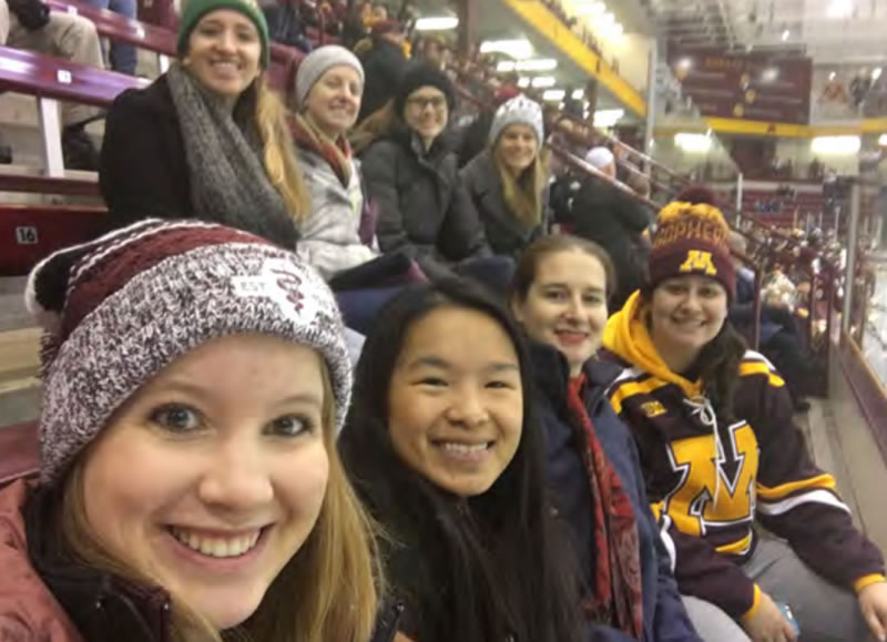 Alumni and current students at a Gopher hockey game.