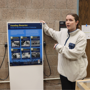 Mari Kuennen stands next to an exhibit