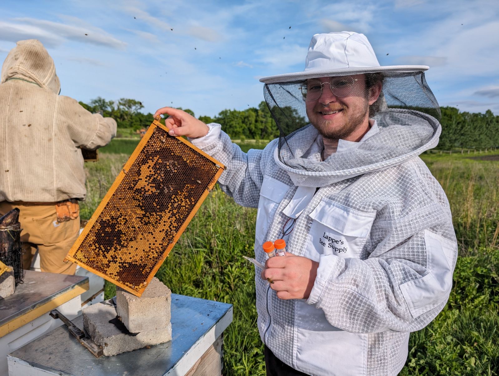 Second-year veterinary student Mo Usavage conducts field research on a bacterial disease affecting honey bees.  