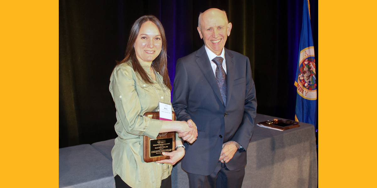 Dr. Maria Pieters (left) accepts the 2024 Distinguished Service Award from outgoing MVMA President Dr. Jim Bennett.