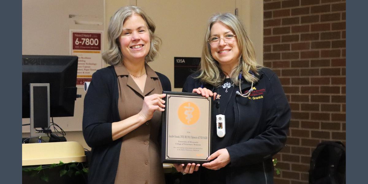 Dr. Jennifer Granick (right) receives the Zoetis Distinguished Teaching Award from CVM Dean Dr. Laura Molgaard.