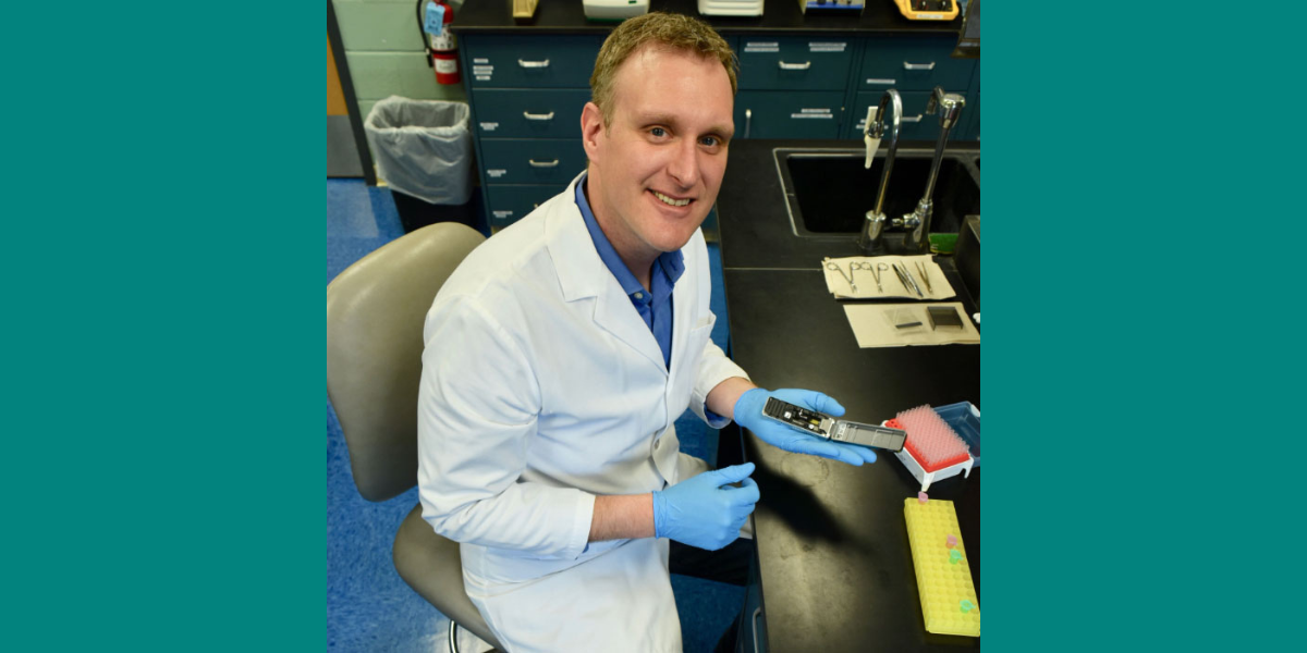 Peter Larsen holds a tool in his lab. 
