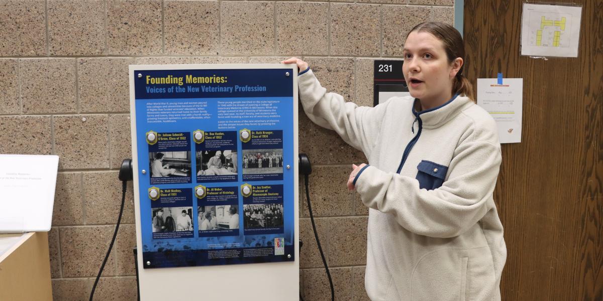 Mari Kuennen stands next to an exhibit