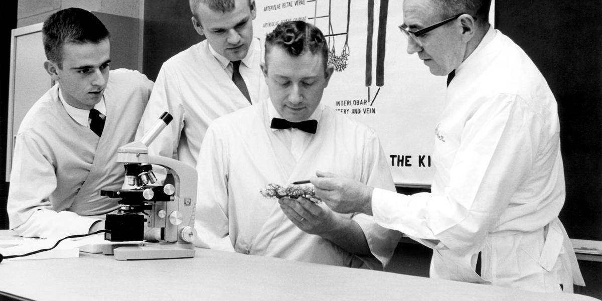 Al Weber helps students in his histology lab in 1964. (From left to right) Bob Gehrman, '68 DVM; Robert Peters, '68 DVM; Robert Velure, '68 DVM; and Al Weber
