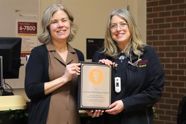 Dr. Jennifer Granick (right) receives the Zoetis Distinguished Teaching Award from CVM Dean Dr. Laura Molgaard.